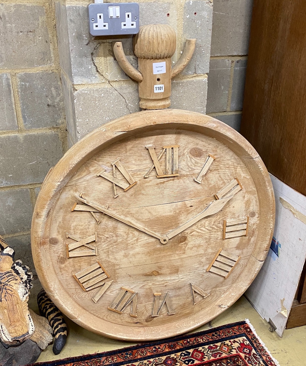 A carved pine model of a pocket watch, height 110cm